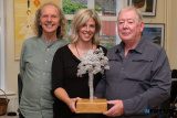 Anne Harper, Rostrevor Action Respecting the Environment presents the Invisible Tree award to Paul Clerkin, Rostrevor in honour of his work with trees in Kilbroney. Looking on is Colum Sands. - Fiddlers Green Festival 2023