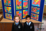Clodagh Small and Arham Mirza from P2 at St Malachy's PS with some of the P2 art work. Photograph: Columba O'Hare/ Newry.ie  - St Malachy's PS Art Exhibition for Anti Bullying Week