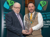 Chairperson Councillor Pete Byrne presents Michael Mallon with a Civic Award in the Arts Awards Category for his dedication to highlighting the history of Newry and surrounding areas.  - Newry, Mourne and Down District Council Civic Awards 2024