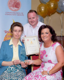 Bernadette Sands, Newry Gateway Club is pictured receiving her Shining Light Award in Age 50-64 Category, from Kathie Mallie, Clanrye Taxis, sponsors with Shea Graham, family representative. Photograph: Columba O'Hare - Shining Light Awards 2017