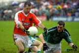 Composed - Armagh's Steven McDonnell, beats Limericks, Stephen Lavin to place the ball in the back of the net, in attrocious conditions at Roscommon. Photo: Columba O'Hare - Armagh v Limerick July 2003