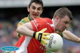 Armagh's Ronan Clarke launches an attack at Croke Park in the Ulster Final while Donegal's Paddy Campbell closes in. - Armagh v Donegal Ulster Final 2006