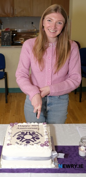 Emily Skelly, Poyntzpass Community Pre-School Leader cuts the cake for the 40th Anniversary celebrations.