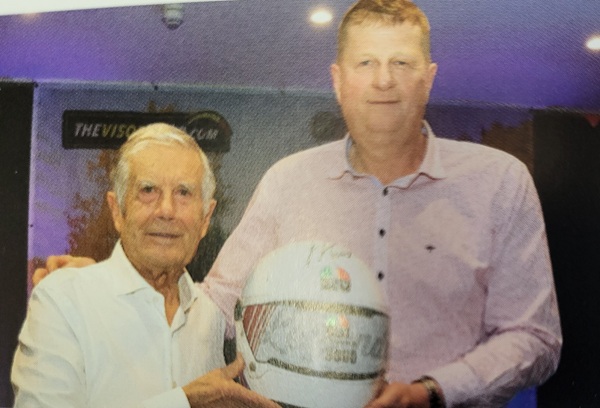 Tommy Maxwel, Maxwell Freight, Antrim the winning bider receives the helmet from 15 times World Champion Giacomo Agostini.