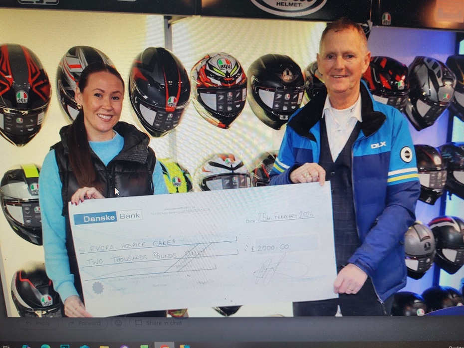 Adrian Fegan Crossan Motorcycles presenting the cheque to Alison Donaghy from Evora Hospice.