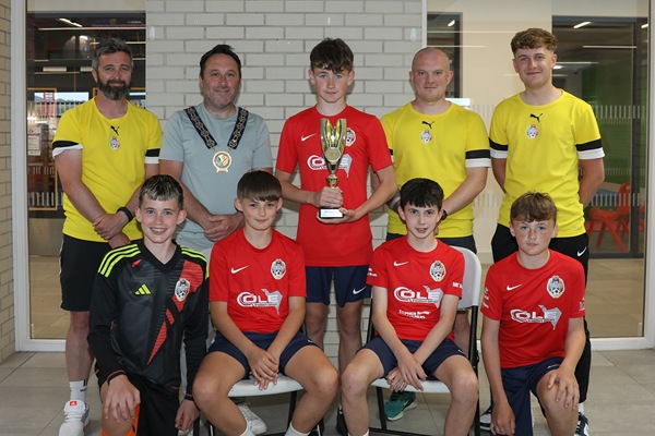 Newry, Mourne and Down District Council Chairperson, Councillor Pete Byrne with the youth teams across the 2012 age group who represented the district at the prestigious 2025 Nations Cup held in Barcelona, and their coaches, Ben Ryan, Conor Fegan, Dylan Morgan-Longfield and Ethan Doyle (not present).