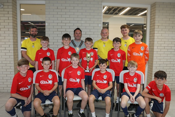 Newry, Mourne and Down District Council Chairperson, Councillor Pete Byrne with the youth teams across the 2013 age group who represented the district at the prestigious 2025 Nations Cup held in Barcelona, and their coaches, Ben Ryan, Conor Fegan, Dylan Morgan-Longfield and Ethan Doyle (not present).