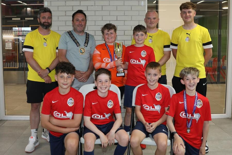 Newry, Mourne and Down District Council Chairperson, Councillor Pete Byrne with the youth teams across the 2014 age group who represented the district at the prestigious 2025 Nations Cup held in Barcelona, and their coaches, Ben Ryan, Conor Fegan, Dylan Morgan-Longfield and Ethan Doyle (not present).