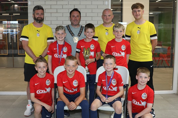 Newry, Mourne and Down District Council Chairperson, Councillor Pete Byrne with the youth teams across the 2015 age group who represented the district at the prestigious 2025 Nations Cup held in Barcelona, and their coaches, Ben Ryan, Conor Fegan, Dylan Morgan-Longfield and Ethan Doyle (not present).