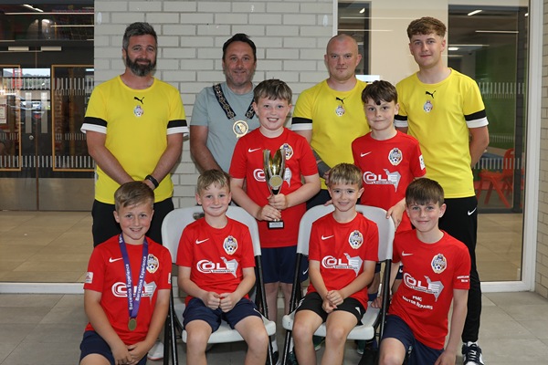 Newry, Mourne and Down District Council Chairperson, Councillor Pete Byrne with the youth teams across the 2016 age group who represented the district at the prestigious 2025 Nations Cup held in Barcelona, and their coaches, Ben Ryan, Conor Fegan, Dylan Morgan-Longfield and Ethan Doyle (not present).