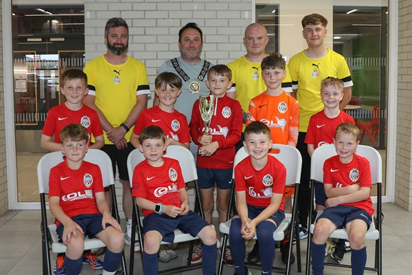 Newry, Mourne and Down District Council Chairperson, Councillor Pete Byrne with the youth teams across the 2017 age group who represented the district at the prestigious 2025 Nations Cup held in Barcelona, and their coaches, Ben Ryan, Conor Fegan, Dylan Morgan-Longfield and Ethan Doyle (not present).