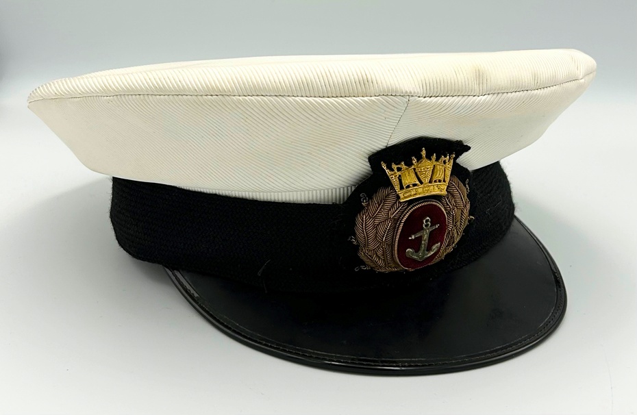Cap worn by Captain John McParland. John McParland was born into a Newry seafaring family He became a Deck Boy on the SS Bamboo in April 1951 and continued a successful career in the merchant navy until his retirement in 1982. His last command was the MV Esso Tenby. Newry and Mourne Museum Collection