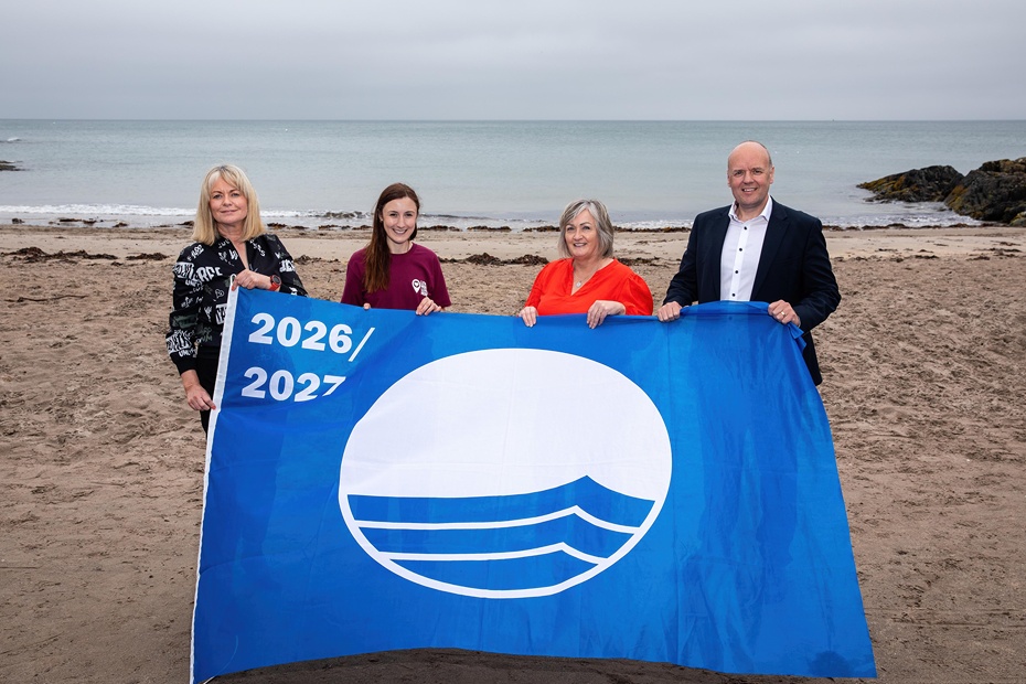 Newry, Mourne and Down District Council Countryside Warden at Tyrella Beach Cara Ryan (left), with the prestigious Blue Flag award alongside Sinead Murray (second left) Local Environmental Quality Manager at Live Here Love Here, NMDDC Assistant Tourism Development Officer Barbara Fleming-Ovens and Live Here Love Here Board Member, John Thompson.