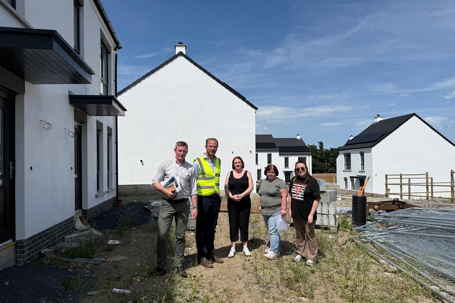 Justin McNulty MLA with local residents at the Parkhead development