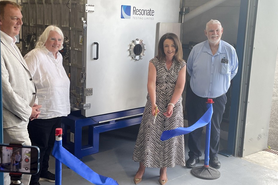 Infrastructure Minister Kimmins cuts the ribbon of the Thermal Vacuum (TVAC) with Robert Hill, Director of the NI Space Office and NI Space Cluster Manager, Donna Mallon Director at Resonate Testing and Tom Mallon, Resonate Managing Director: Caption 2 Infrastructure Minister Liz Kimmins is welcomed to Resonate Testing by their Managing Director Tom Mallon as the company launch their new Thermal Vacuum capability 