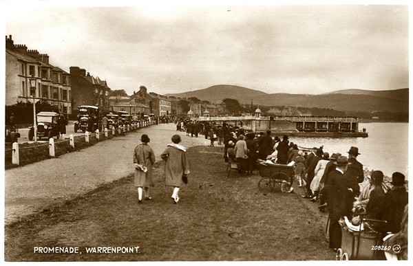 Postcard featuring visitors on the promenade in Warrenpoint. The swimming baths can be seen in the background, 1929. Newry & Mourne Museum Collection