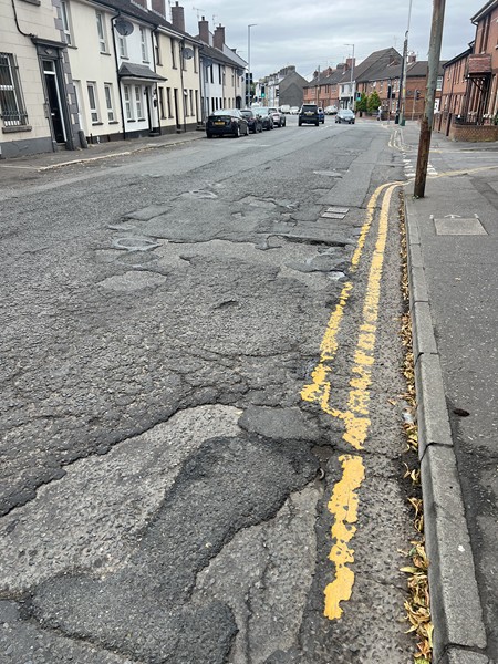 The damaged road surface at Dominic Street.