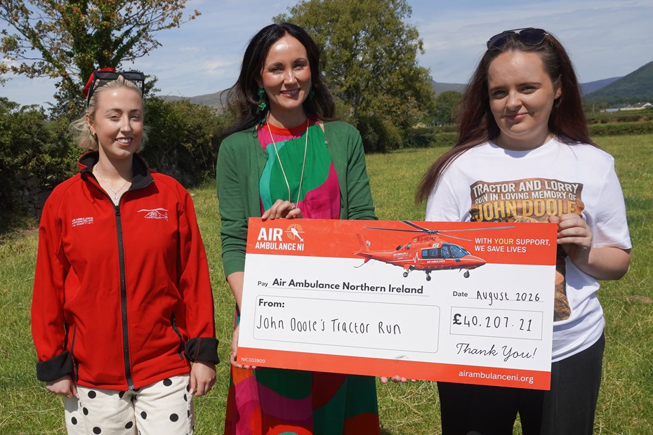 Katie Killen presents a cheque for £40,207.21 to Bébhionn Hardy and Kerry Anderson from Air Ambulance NI.