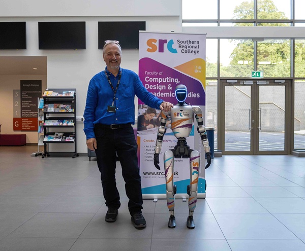 Stephen Herron, SRC Computing Curriculum Area Manager alongside one of the Unitree Robots purchased to allow students to get hands on with emerging technology.  