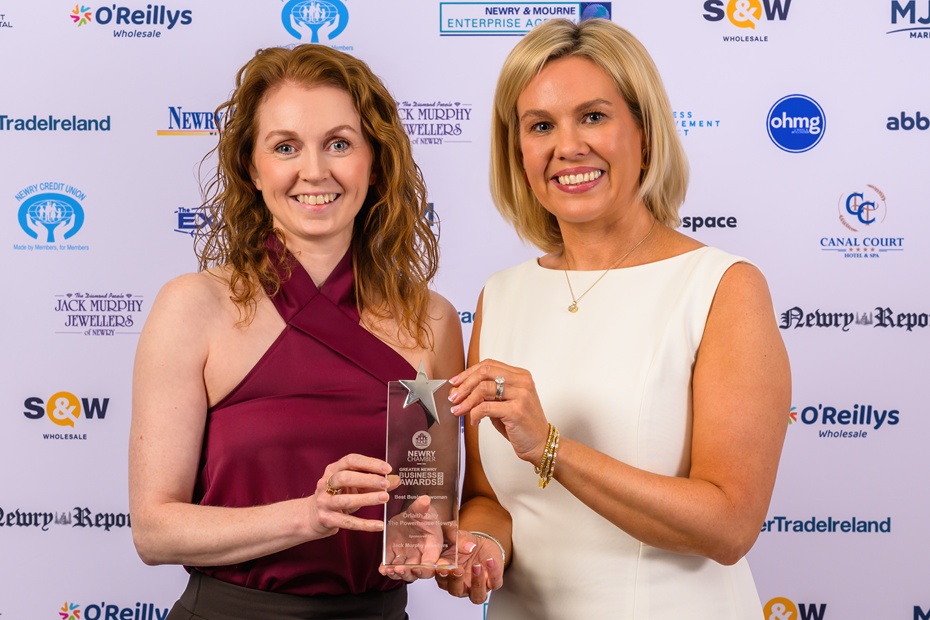 Orlaith Talty, left, from The Powerhouse Newry receives her award for the Best Businesswoman at the Greater Newry Business Awards. Talty is pictured here receiving her trophy from Gemma Murphy, Murphy Jewellers, Sponsors. Photograph: Colum Lynch Photography