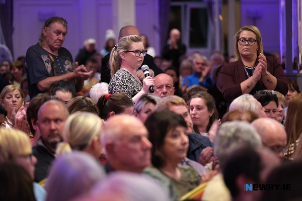 A mother tells her story at the public meeting.