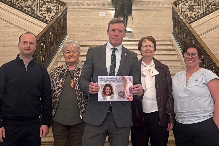 Justin McNulty presents the petition to the Stormont Assembly along with members of the Sherry and Garvey family.