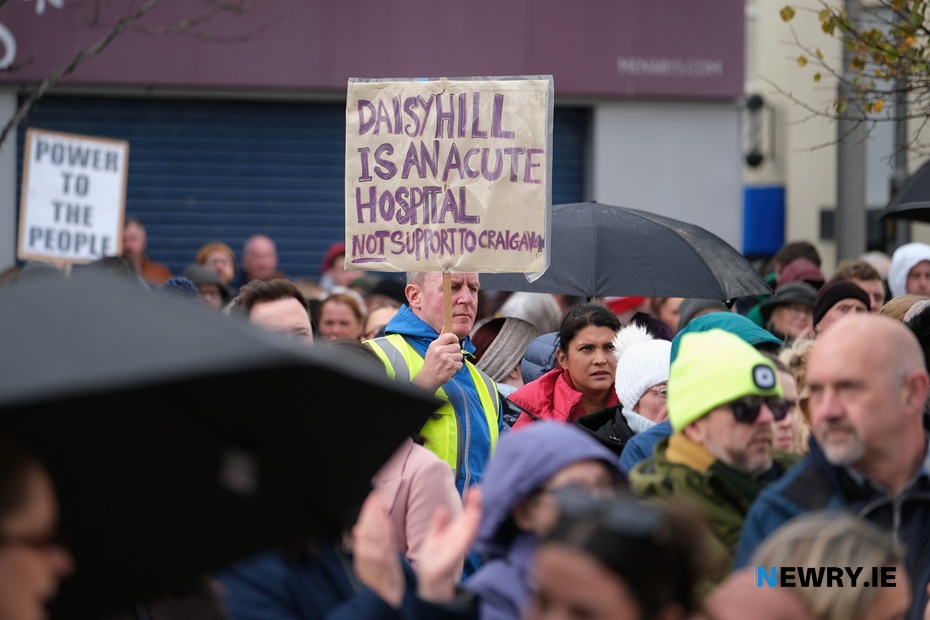 Justin McNulty MLA holds a banner aloft at the rally. Photograph: Columba O'Hare/ Newry.ie 