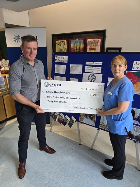 MLA Justin McNulty presents a cheque to Evora Hospice
