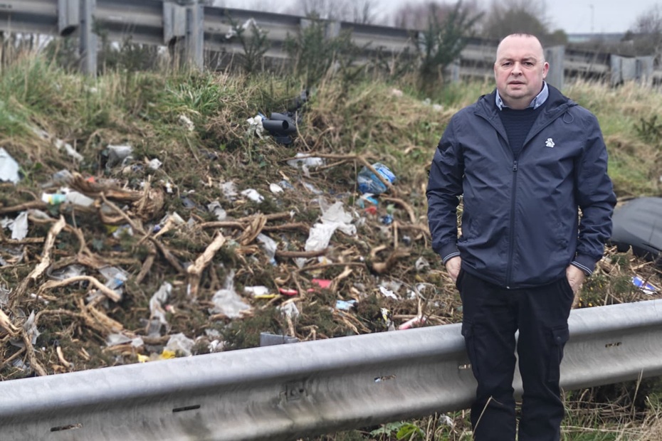 Cllr Aidan Mathers highlights litter on the side of the A1 dual carriageway.