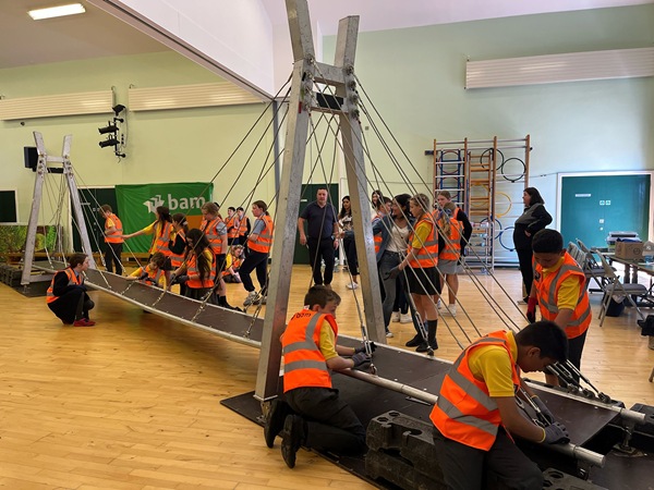 Schoolchildren work on their bridge project.