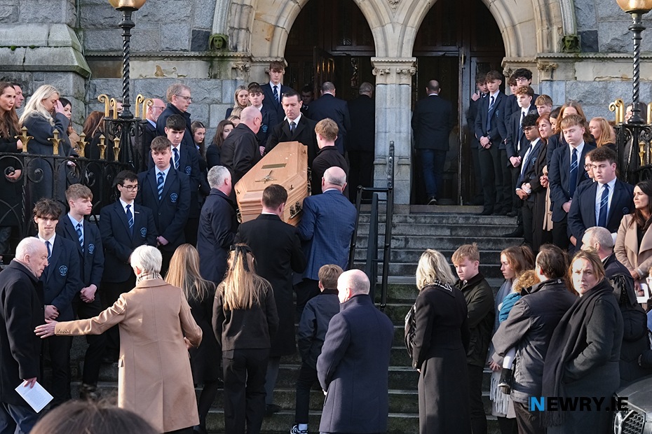 The remains of Fionnuala Hartigan are carried into St Catherine's Dominican past a Guard of Honour from St Patrick's College, Banbridge.