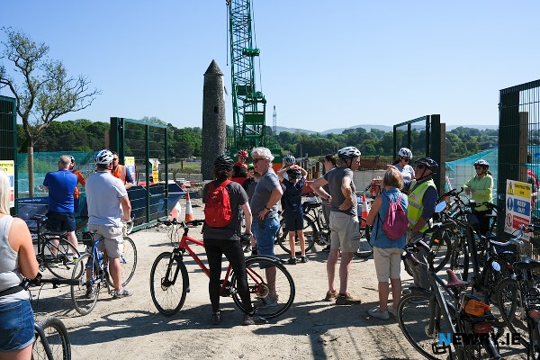 Cyclists pause at the location of the Narrow Water Bridge.