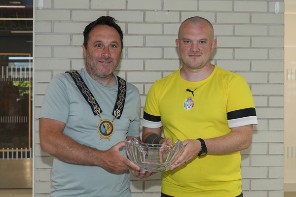 Newry, Mourne and Down District Council Chairperson, Councillor Pete Byrne presents lead coach, Conor Fegan a crystal bowl to lead coach, Conor Fegan in recognition of his leadership and contribution to the teams’ success.