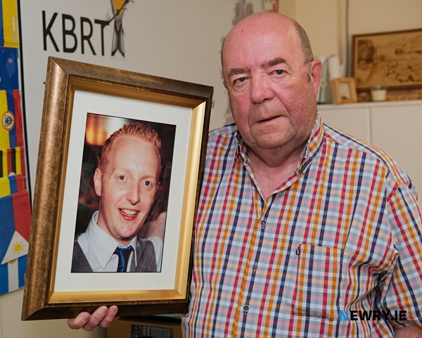 Colin Bell with a photograph of son Kevin.