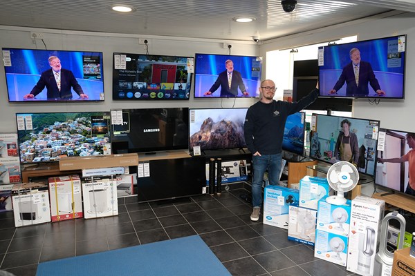Tim Stewart with a selection of TVs