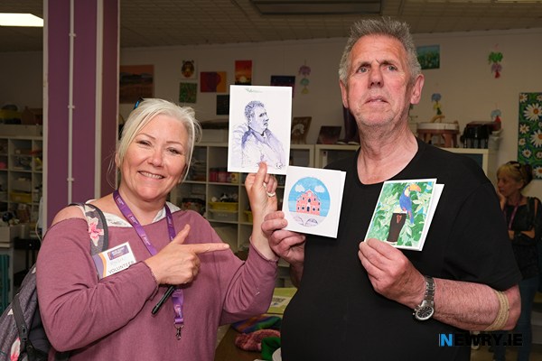 Head Injury Support volunteer Roisin Cunningham with service user Peter Hobden and some of their art.