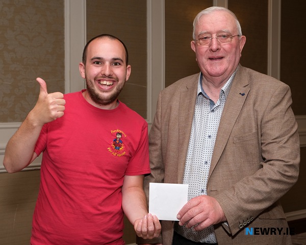 Nathan Pierson accepts a donation on behalf of Angel Wishes from Paddy McParland, Canal Court Hotel