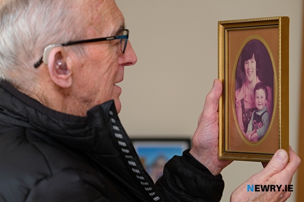 Alphie looks at a photograph of his late wife Nellie and son Donall.