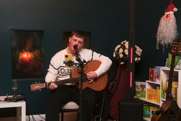 Connor Reavey singing at the launch of c0mm0n.