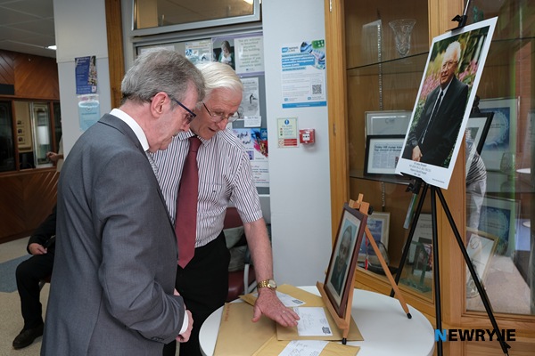 John Davis shows Stephen Travers photographs he took of some of the medical staff that looked after him in 1975 following the Miami Showband massacre.