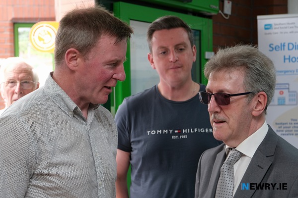 Miami Showband member Stephen Travers, right, speaking to Justin McNulty MLA and Cllr Killian Feehan.