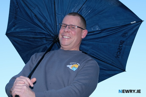Brolly good - Kieran Meaney shelters from the elements. Photograph: Columba O'Hare/ Newry.ie 