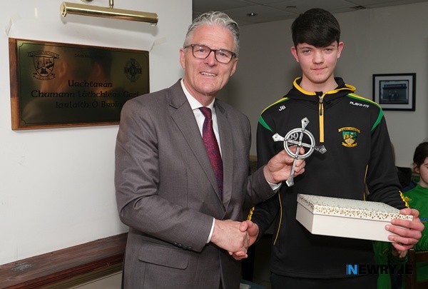 James Byrne, St Michael's GAC U16 team presents a gift to GAA President Jarlath Burns to commemorate his visit to the club. Photograph: Columba O'Hare/ Newry.ie 