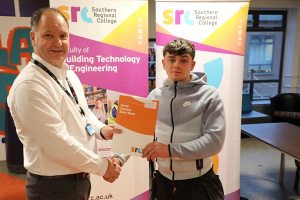 Frank Finlay from Rathfriland who achieved second place in carpentry at the 2026 SRC Intercampus SkillBuild competition.  Frank is pictured alongside Curriculum Area Manager Gareth Mone.