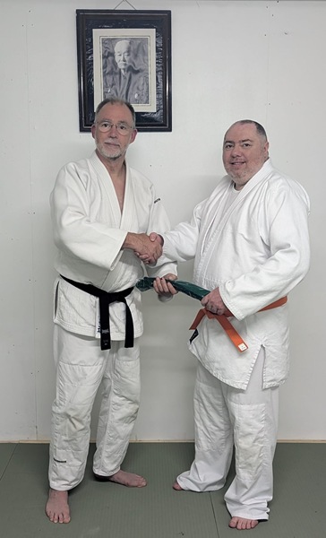 Gerard receives a Green Belt from Dermot.