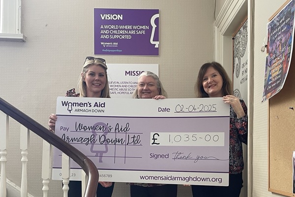 Warrenpoint Art Group committee members Aisling and Catherine presenting cheque to Eileen Murphy, Womens Aid Armagh Down 