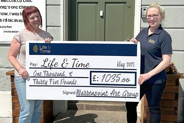 Warrenpoint Art Group committee member Sarah presenting cheque to  Life and Time 