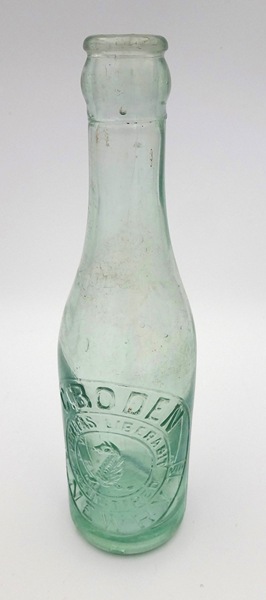 A Boden's moulded clear glass bottle