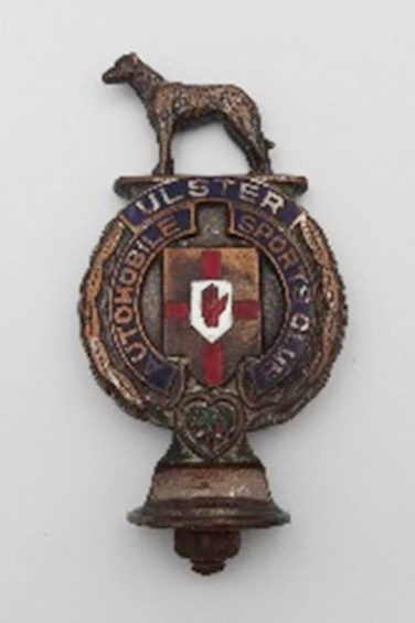 This Ulster Automobile Sports Car Club badge  features the Irish wolfhound, the Ulster coat of arms and a shamrock.  Newry & Mourne Museum Collection.