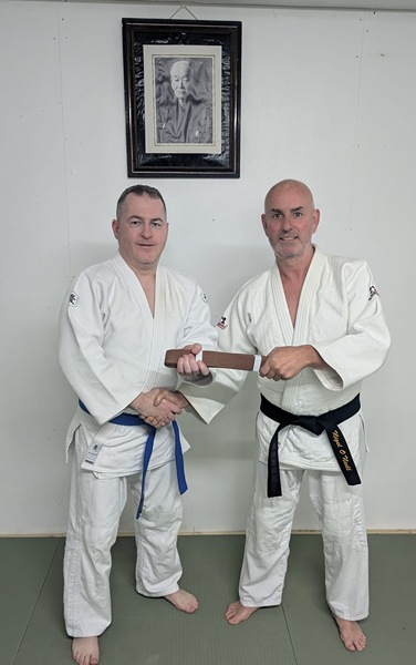 James receives a Brown Belt from Nigel.